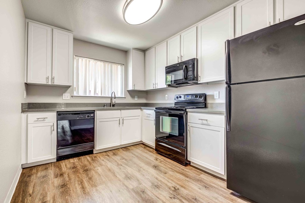 a kitchen with stainless steel appliances and white cabinets
