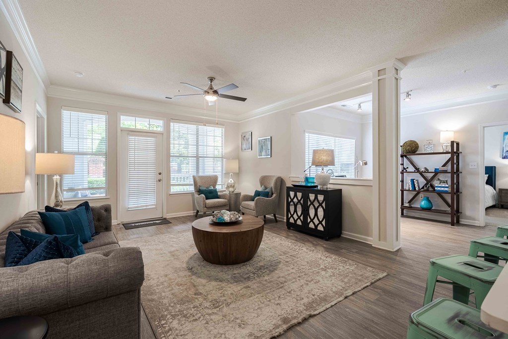 a living room with furniture and a ceiling fan