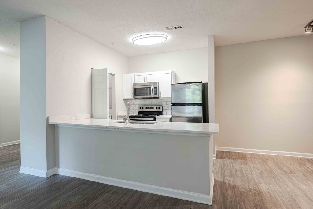 a kitchen with a counter top and a refrigerator