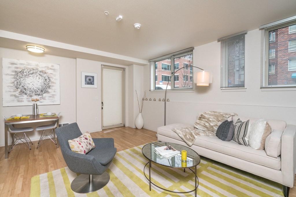 a living room with a couch and a chair and a table