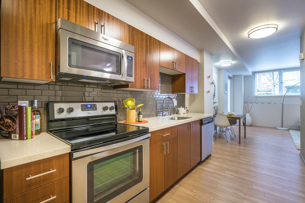 a kitchen with stainless steel appliances and wooden cabinets
