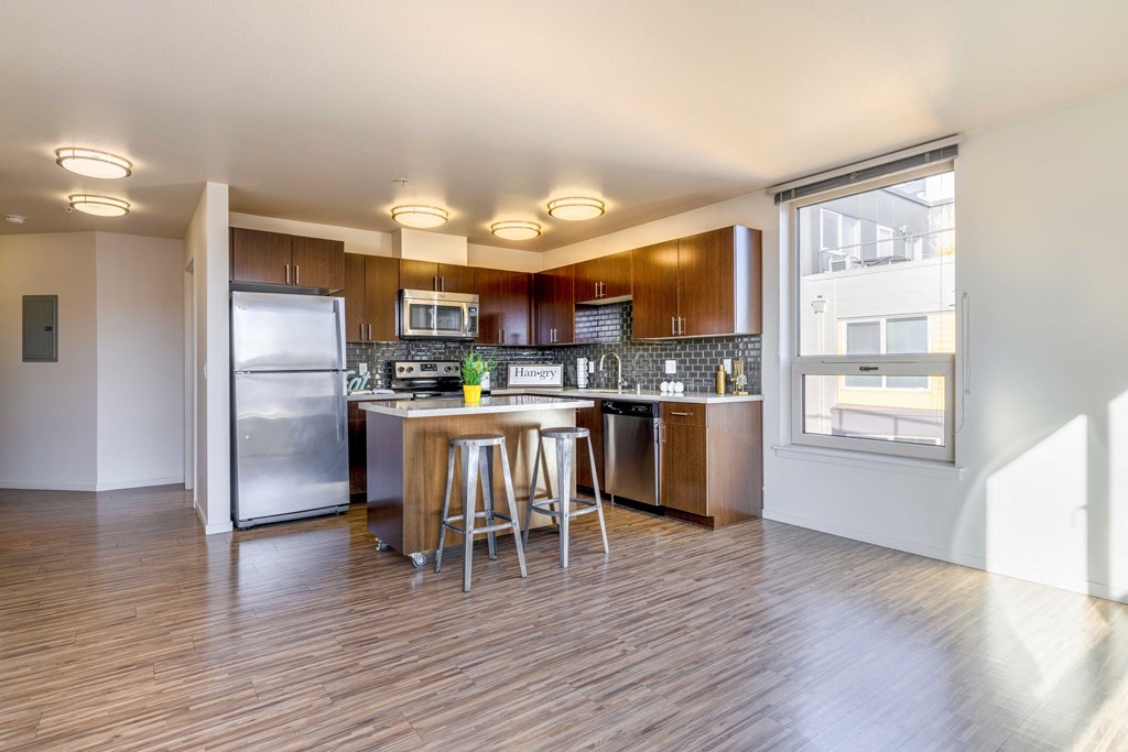a kitchen with stainless steel appliances and wooden cabinets
