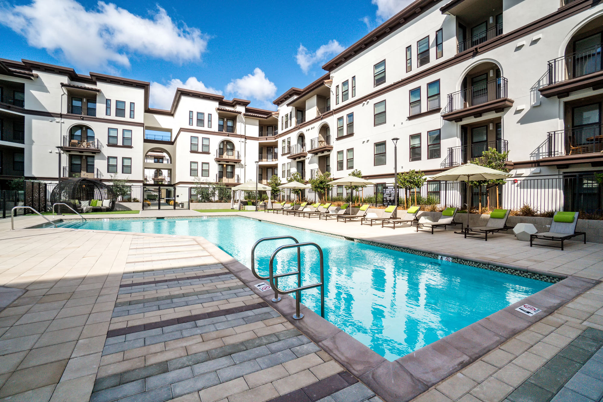 One-Bedroom Apartments In Santa Clara, CA - Villas On The Boulevard - Swimming Pool With Lounge Chairs, Umbrellas, Day Beds, And Maintained Landscaping