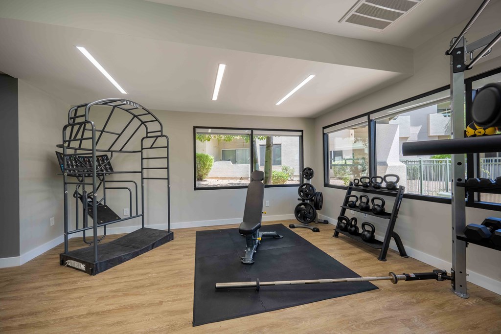Affordable Apartments in Lakewood, AZ - Village at Lakewood - Fitness Center with a Bench Press, Dumbells, and Free Weights.