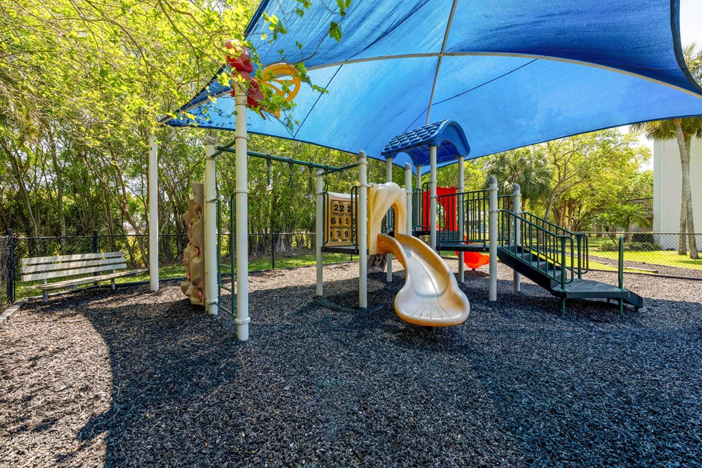 Pet-Friendly Apartments in Coconut Creek, FL – Waterview at Coconut Creek – playground with a slide and other playground equipment