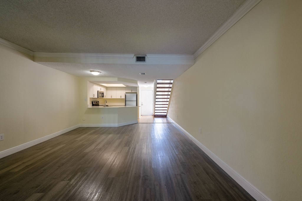 Apartments In Coconut Creek for Rent – Waterview at Coconut Creek – living room with wood floors and a staircase