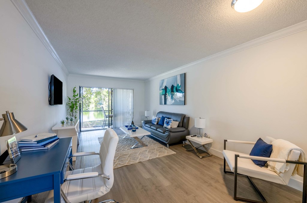 Coconut Creek Apartments – Waterview at Coconut Creek – living room with white walls and a sliding glass door to a patio