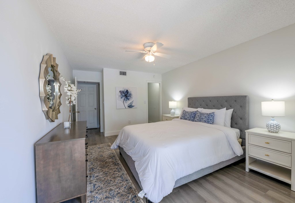 Apartments In Coconut Creek for Rent – Waterview at Coconut Creek – bedroom with ceiling fan, hardwood floors, a bed and a dresser