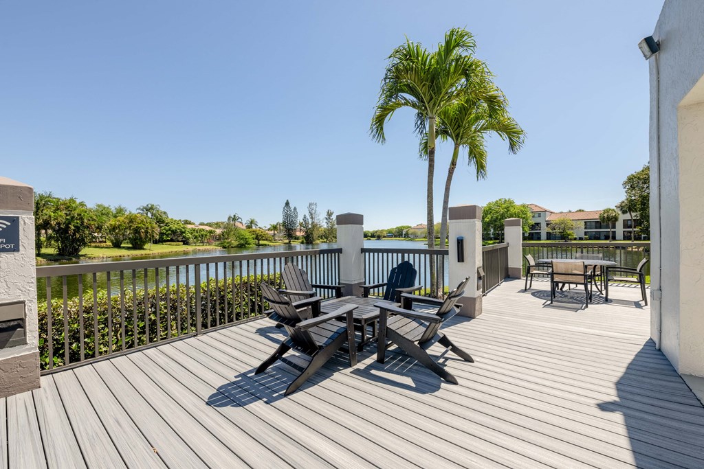 Coconut Creek Apartments – Waterview at Coconut Creek – deck has a palm tree and chairs on it