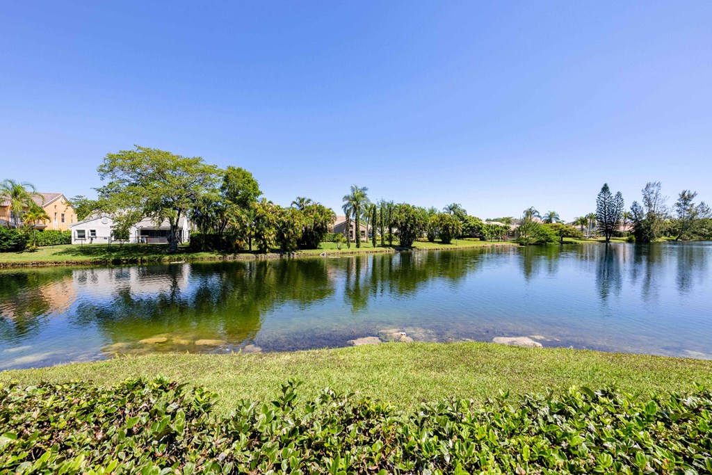 Coconut Creek Apartments – Waterview at Coconut Creek – view of lake with trees and other plants around it