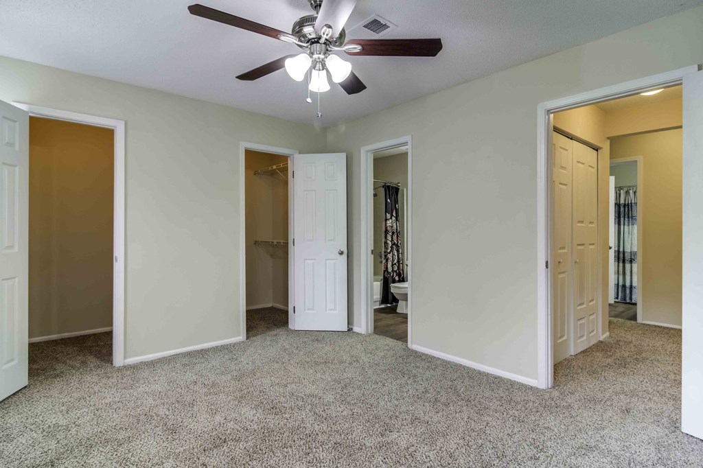 Wood Pointe Apartment Homes in Marietta Georgia photo of a bedroom with three doors and a ceiling fan