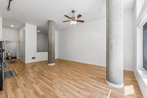 A room with wooden floors and a ceiling fan.