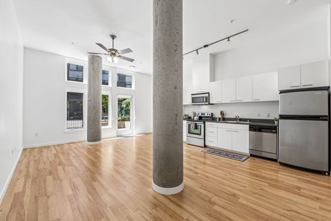 A kitchen with white cabinets and a refrigerator.