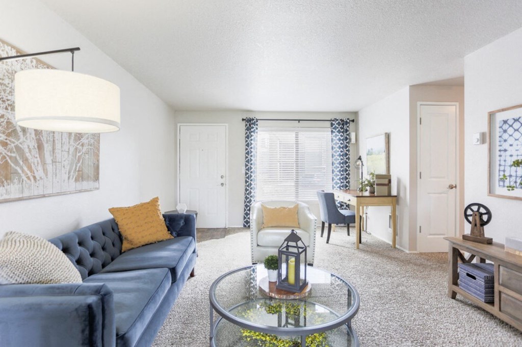Apartments in Wilsonville, OR with In-Unit Washer and Dryer - Boulder Creek - Living Room with a Desk, an Oversized Window, and a Large Couch