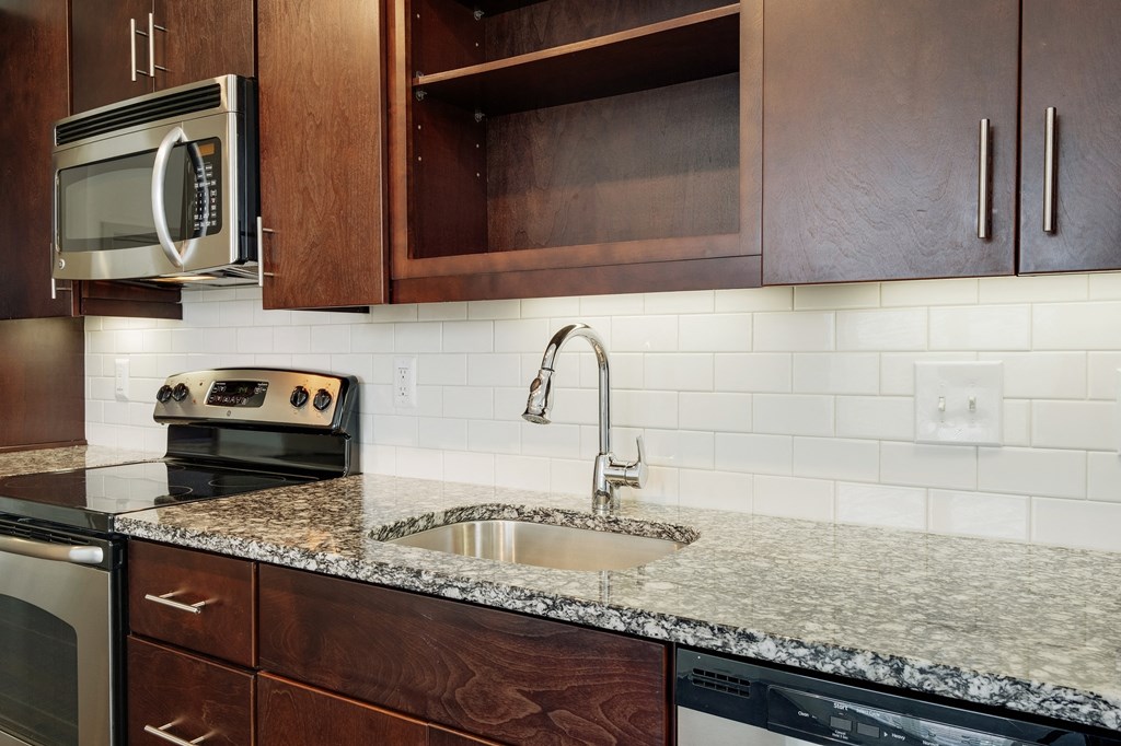 12 South Apartments - Nashville TN - kitchen with dark wood cabinets and stainless steel appliances