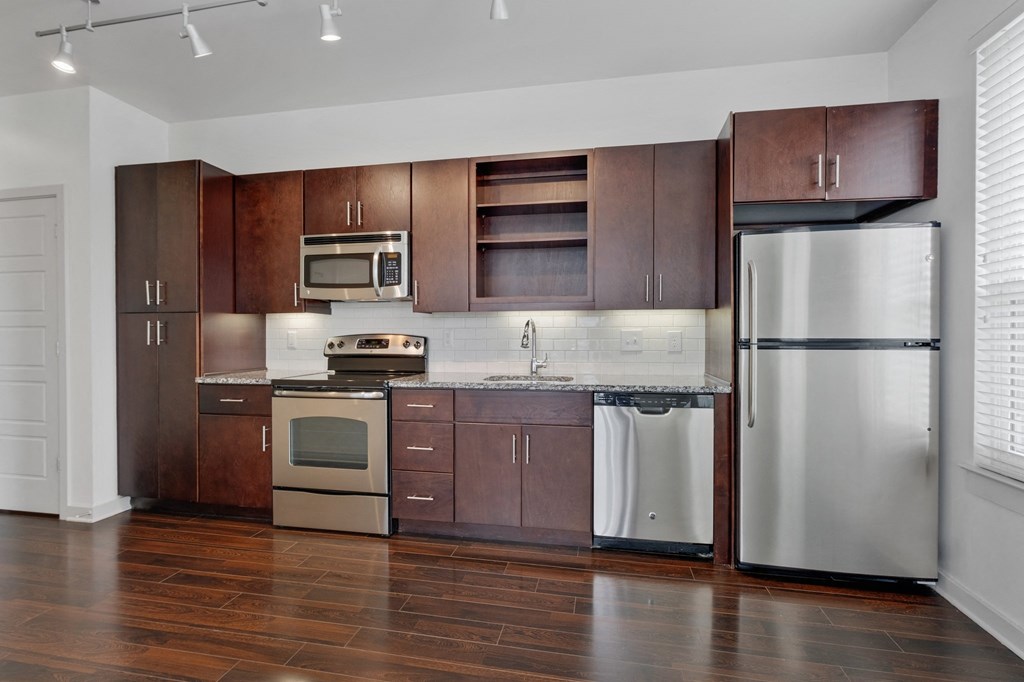 12 South Apartments - Nashville TN - kitchen with dark wood cabinets and stainless steel appliances