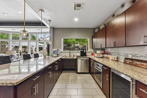 A kitchen with brown cabinets and a granite countertop.