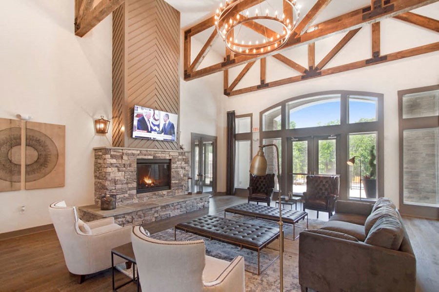 the living room has a stone fireplace and a large window