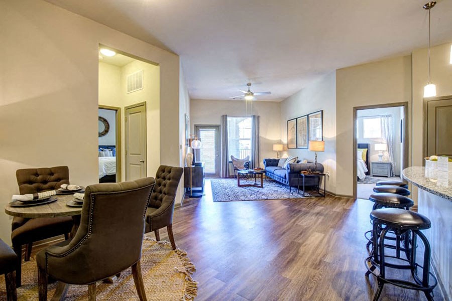 a living room and dining room with a table and chairs