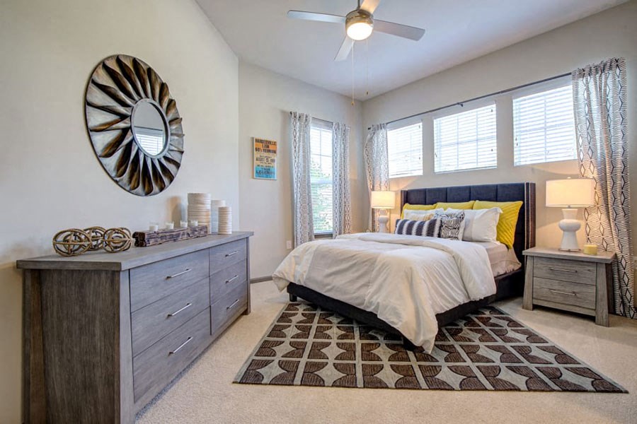 a bedroom with a bed and a ceiling fan