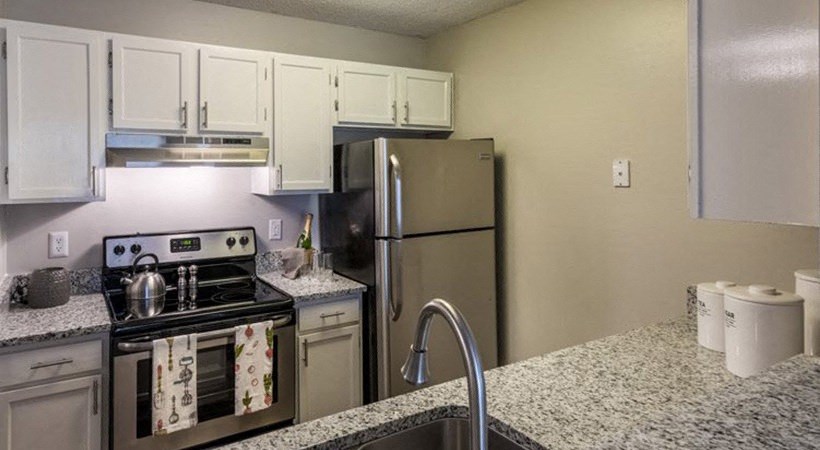 a kitchen with stainless steel appliances and granite counter tops