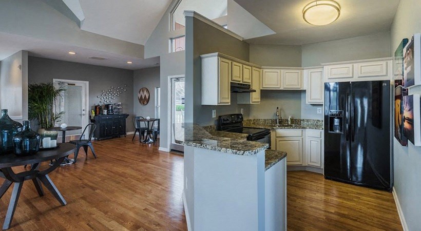 a kitchen and dining room with a black refrigerator