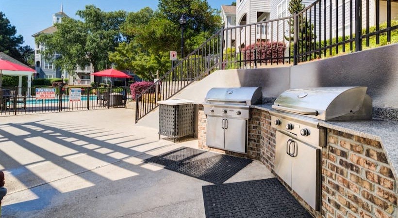 a patio with a grill and a barbecue grill