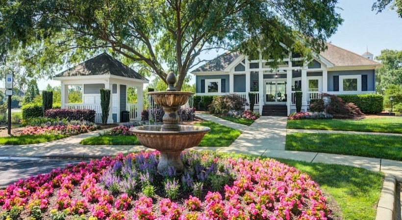 a house with a fountain in front of it