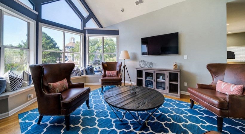 a living room with leather furniture and a large window