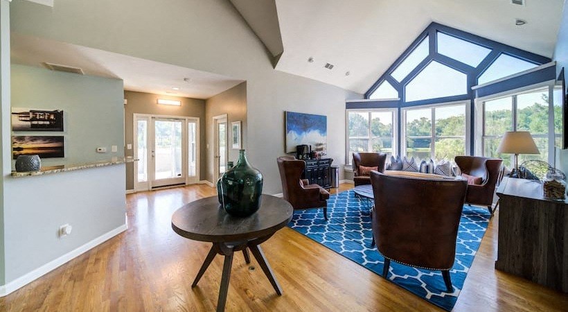 a living room with a table and chairs and a large window