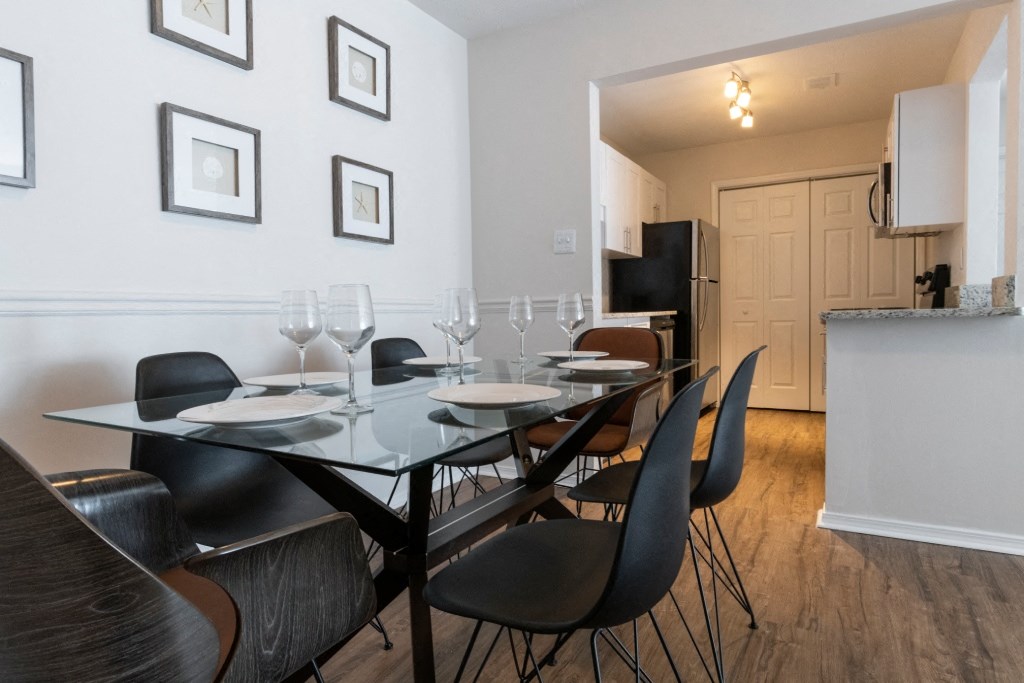 Pet-Friendly Apartments in Alpharetta, GA – Webb Bridge Crossing – dining room with a table and chairs and a kitchen in the background