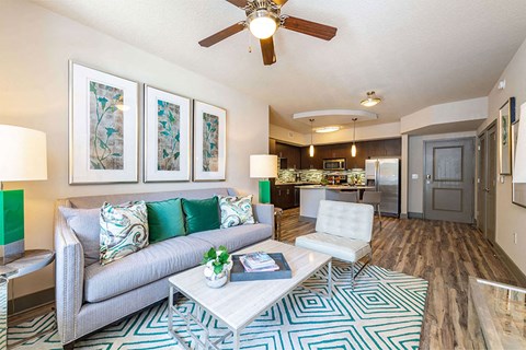 a living room with a couch and a ceiling fan