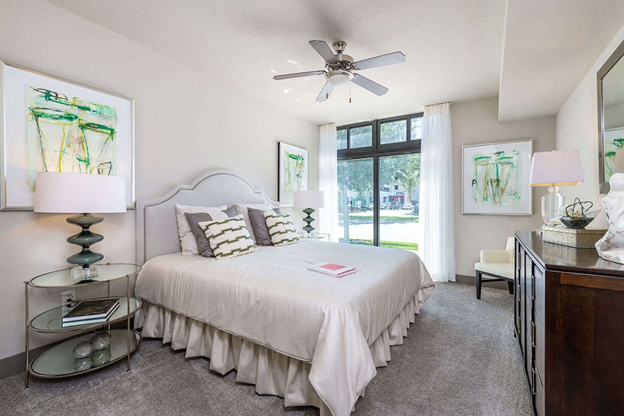 The Edge at Flagler Village Apartments in Fort Lauderdale, FL photo of a bedroom with a bed and a ceiling fan