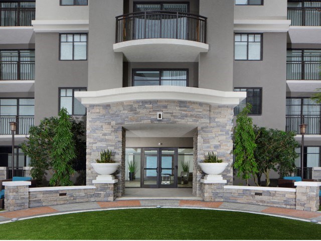 The Edge at Flagler Village Apartments in Fort Lauderdale, FL photo of a large building with a balcony and a front door