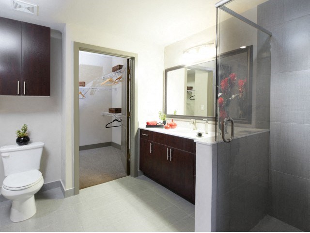 The Edge at Flagler Village Apartments in Fort Lauderdale, FL photo of a bathroom with a toilet and a sink and a shower
