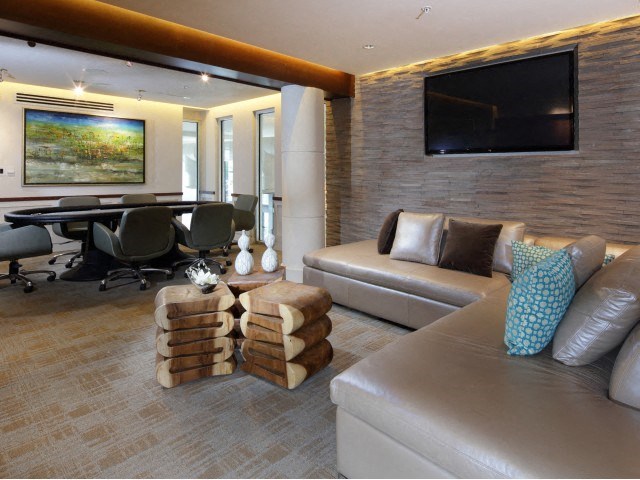 The Edge at Flagler Village Apartments in Fort Lauderdale, FL photo of a clubhouse room with a couch and a table and a television