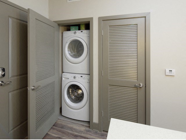 The Edge at Flagler Village Apartments in Fort Lauderdale, FL photo of a white washer and dryer in a small closet