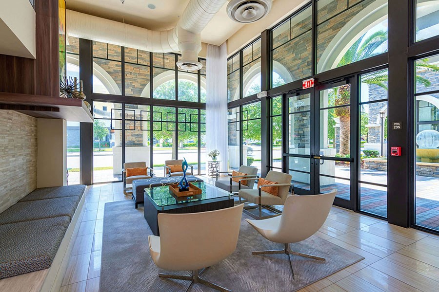 The Edge at Flagler Village Apartments in Fort Lauderdale, FL photo of a lobby with a table and chairs and large windows