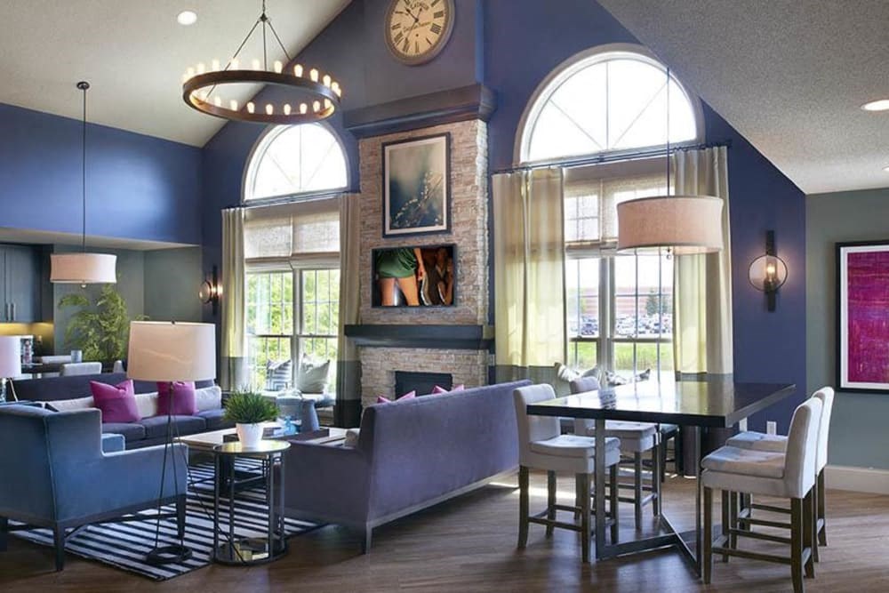 a living room with blue walls and a table and chairs