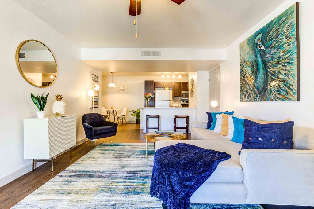 a living room with a white couch and a blue rug