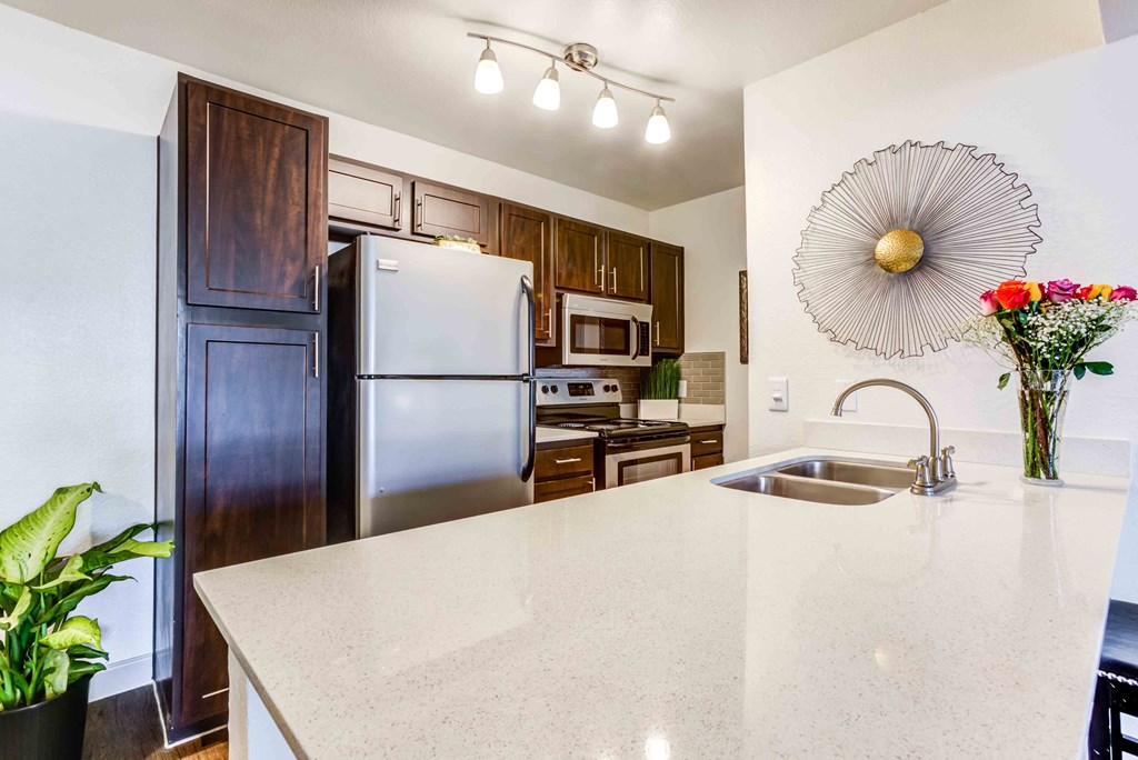a kitchen with stainless steel appliances and a white counter top