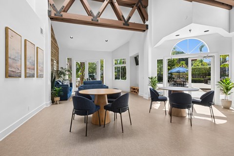 A dining room with a table and chairs.