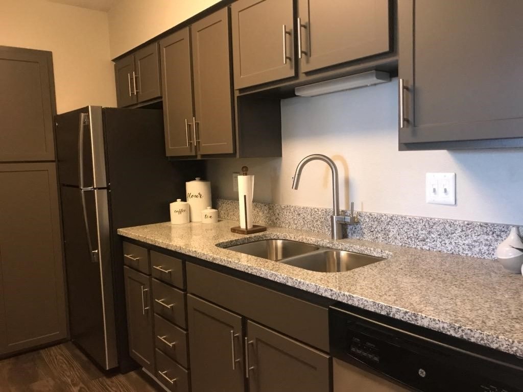 a kitchen with a sink and a refrigerator