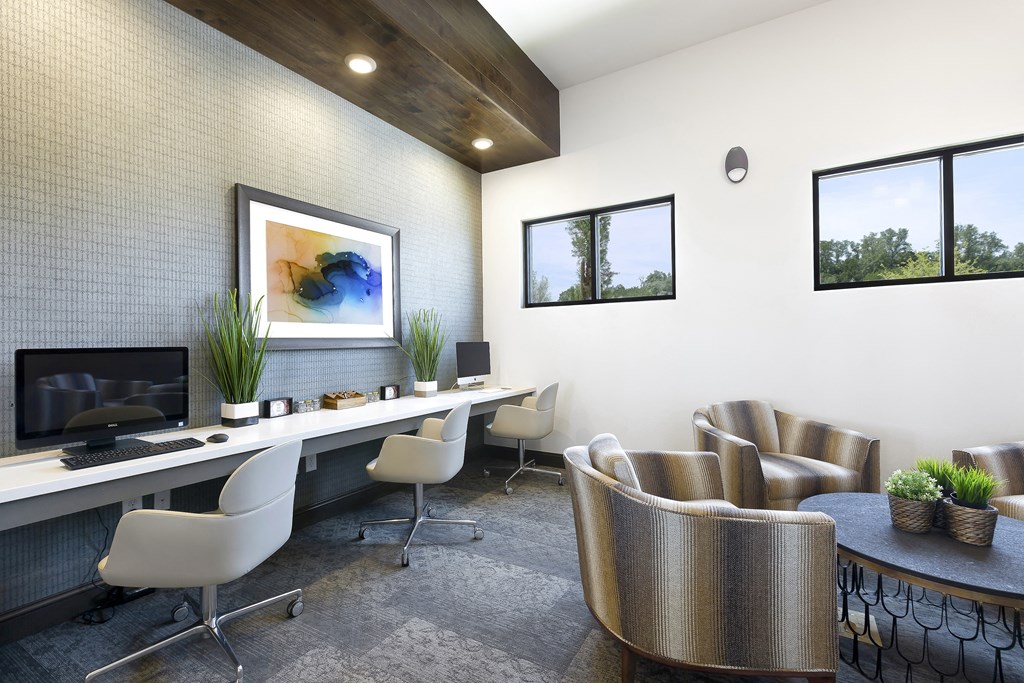 a modern office with chairs and a desk with a computer