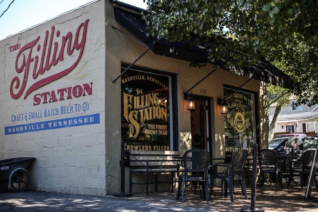 the outside of a restaurant with tables and chairs