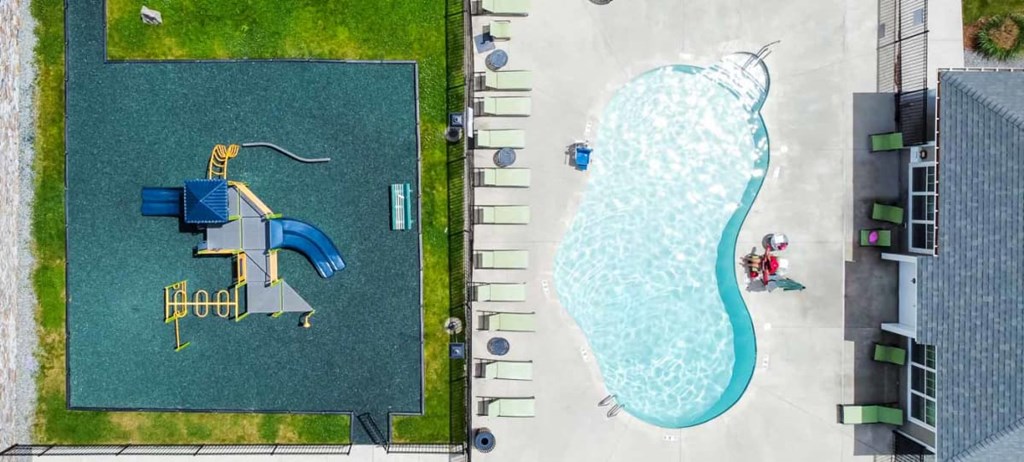 a pool is shown next to a grassy area