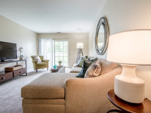 a living room filled with furniture and a flat screen tv