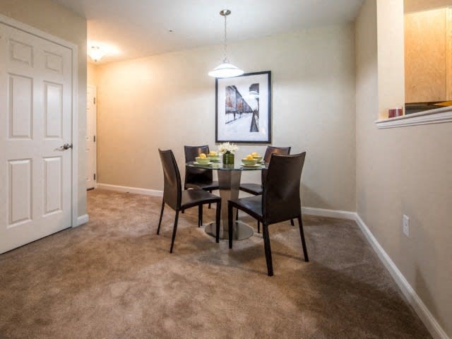 a dining room with a table and chairs