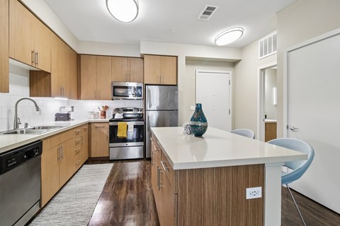 A kitchen with wooden cabinets and a white countertop.