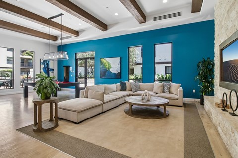 A living room with a white couch and a wooden coffee table.